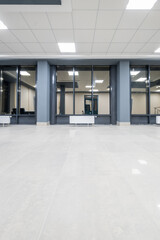 panorama view in empty modern hall with columns, doors and panoramic windows at night