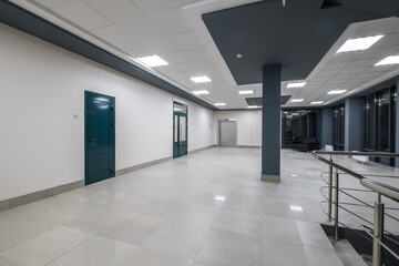 panorama view in empty modern hall with columns, doors and panoramic windows at night