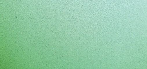 Grüne unifarbene Raufaser mit Farbverlauf als Nahaufnahme und Hintergrundbild mit Platz für Text