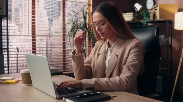 Sad sick ill Caucasian girl freelancer business woman female entrepreneur boss businesswoman in glasses working online laptop typing device suffer headache migraine cephalalgia pain hold head indoors