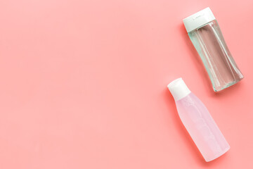 facial tonic and lotion for face care on pink background top view mock up