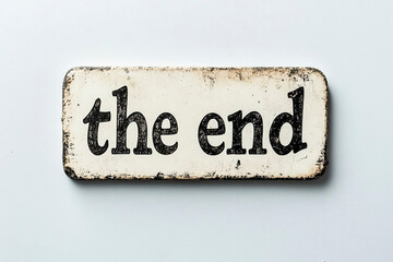 The inscription "the end" is on a rectangular plaque on a bluish wall.