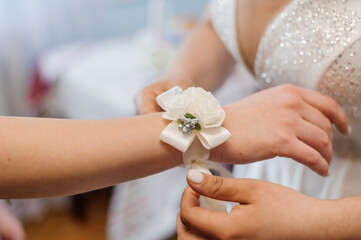 Elegant Bride Receiving Floral Corsage in Bridal Preparation