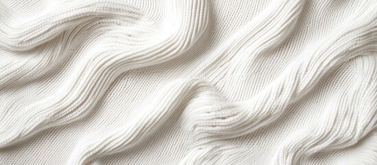 Obraz premium Knitted white sweater texture showcasing intricate wave patterns and soft fibers perfect for fashion and fabric design concepts.
