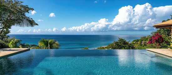 Breathtaking infinity pool overlooking serene ocean landscape with vibrant clouds and lush greenery in tropical setting