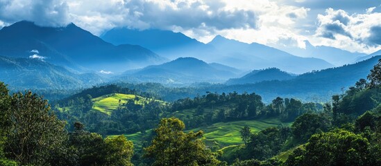 Stunning panoramic landscape showcasing lush mountains and rolling hills under a dramatic cloudy sky in a serene natural setting