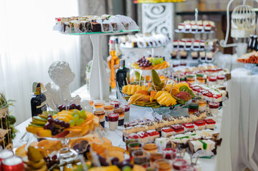 Exquisite Array of Gourmet Desserts and Fresh Fruits at a Lavish Celebration