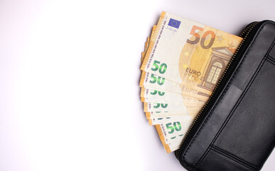 Black leather wallet with fifty euro bills banknotes on white background 