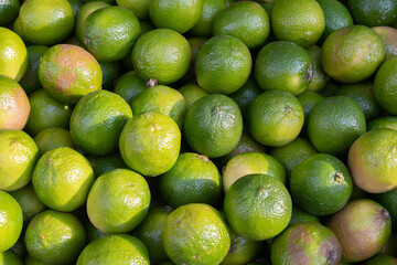 Close-up of many limes at a stall in a random market
