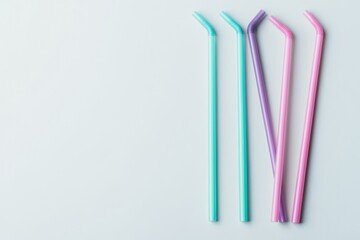 Colorful reusable straws arranged on a light background, showcasing eco-friendly alternatives for drinks.