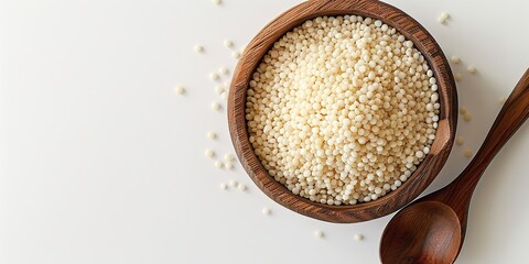 Close-up and top perspective of starch tapioca pearls in a wooden bowl with a spoon&nbsp;set against a stark white background with lots of text area,&nbsp; Generative AI.