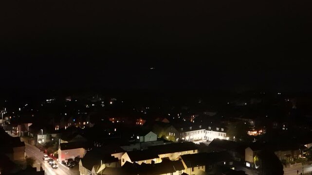 Aerial drone shot of a plane landing at night in Stansted Airport, England