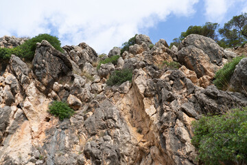 Canyamel, Mallorca, Spain (10/25/2021) - Rugged limestone rock formations with Mediterranean...