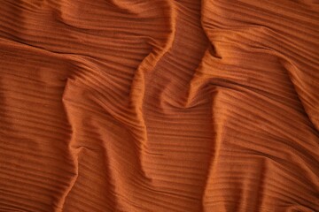 Bright orange fabric background from a piece of crumpled clothes