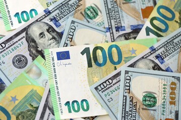 Big pile of Euro and USD banknotes. Many european and united states dollars