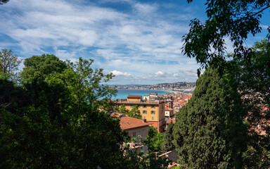 Nice, Provence-Alpes-Cote d'Azur, France - May 3, 2024: Panoramic View of Nice Bay and Mediterranean Sea Through Trees