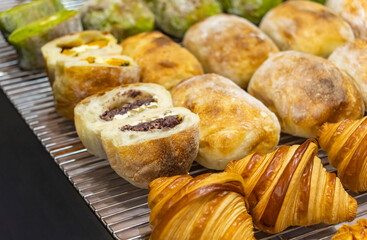 Broken round rustic white bread roll on the counter in the bakery. The process of making bread.