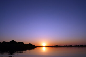 Fototapeta premium Couchers de soleil à Guma lagoon dans le delta de l'Okavango au Botswana