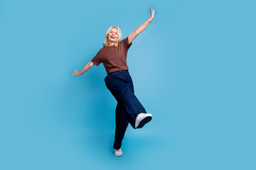 Fototapeta premium Photo of good mood glad lovely senior woman wear trendy brown clothes isolated on blue color background