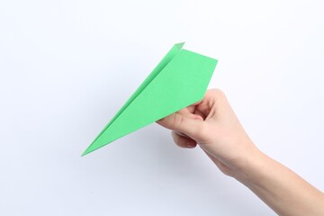 Woman with handmade paper plane on white background, closeup