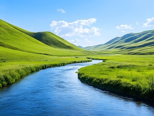 Obraz premium Scenic View of a Serene River Flowing Through Lush Green Hills Under a Bright Blue Sky with Fluffy Clouds