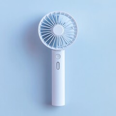 White handheld mini fan on light blue background.