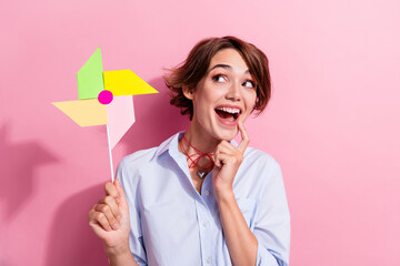 Portrait of minded astonished person finger touch chin hold windmill spinner look empty space...