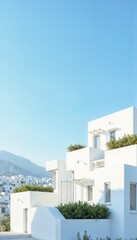 Modern white villa with greenery and mountain view under clear blue sky