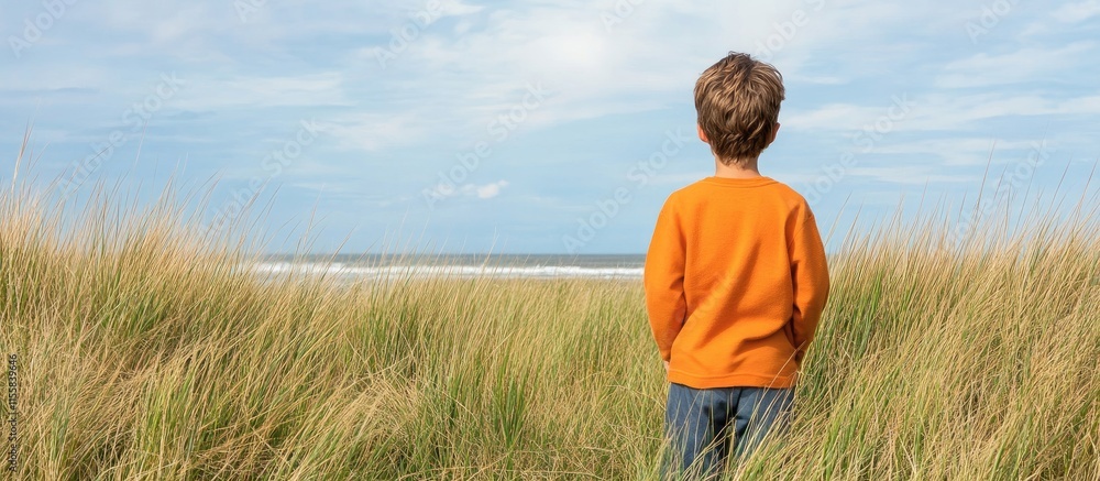 Poster child in a grassy field gazing at the horizon with ample empty space for text or graphics