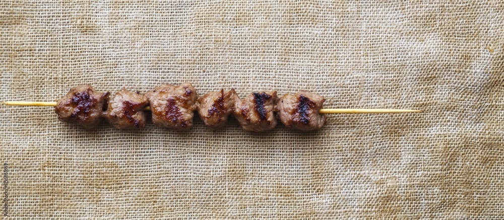 Poster Grilled Beef Skewers on Neutral Background with Space for Text or Branding Purpose