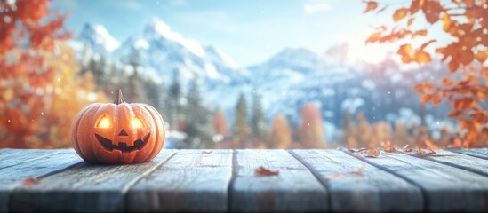 Autumn themed wooden table with carved pumpkin jack o lantern against a blurred fall landscape perfect for seasonal text or decoration