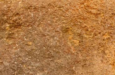 Background of ancient sandstone rock made rugged by the weather