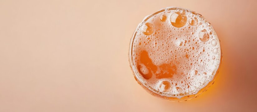 Close up of a glass of beer with foam bubbles on a light background creating a space for text and emphasizing drink enjoyment
