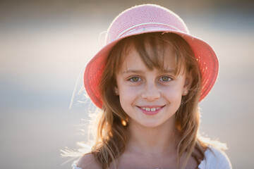 Closeup portrait of a cute little girl in a hat-