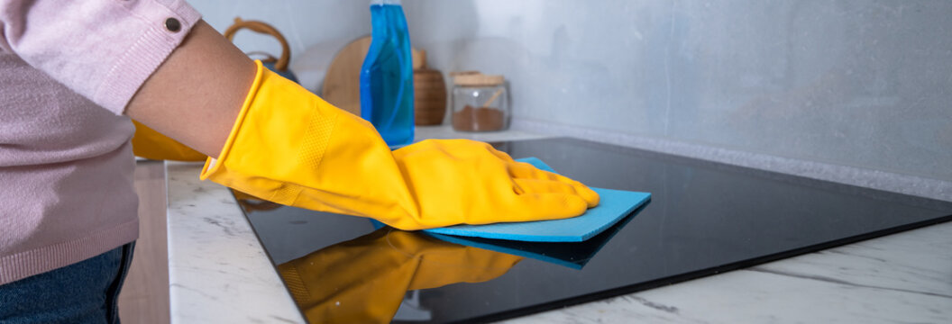 Housekeeper cleaning the kitchen, gas stove, cleanliness concept