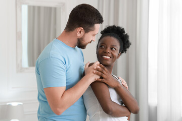 Fototapeta premium International relationships. Portrait of lovely couple at home