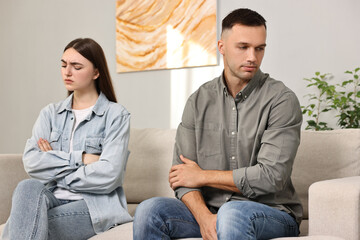 Offended couple ignoring each other at home