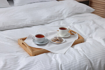 Breakfast tray on bed with beautiful linens indoors