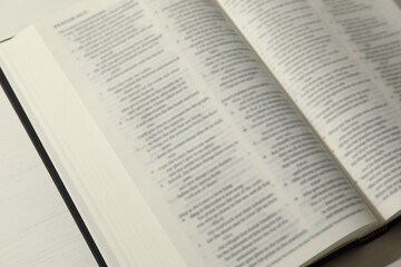 Open Holy Bible in English language on table, closeup