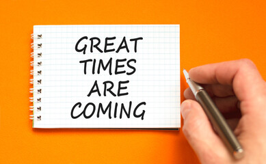 Great times are coming symbol. Concept words Great times are coming on beautiful white note. Beautiful orange background. Businessman hand. Business great times are coming concept. Copy space.