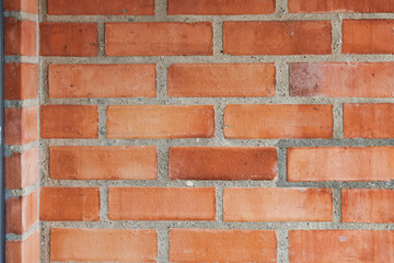 Fototapeta premium Detailed close-up of a red brick wall showing the texture of bricks and mortar