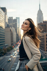 Fototapeta premium Elegant young woman enjoying the cityscape, urban background
