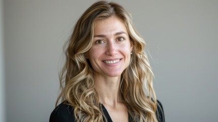 Fototapeta premium Portrait of a Smiling Woman with Long Blonde Hair
