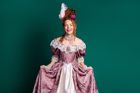 Young woman in baroque costume with joyful expression, modern style photo with historical comparison, green backdrop