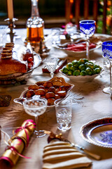 Festive Holiday Dinner Table with Elegant Dishes, Crystal Glassware, and Seasonal Decor