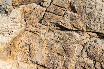Capdepera, Mallorca, Spain 26.10.2021 Natural limestone rock formation showing layered texture and geological patterns in sunlight.