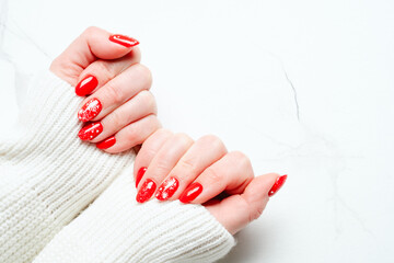 Christmas manicure, Beatiful red nails on white background. Top view with space for design.