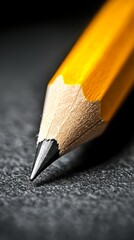 Obraz premium A close up of a yellow pencil on a black surface
