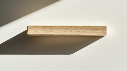 Minimalist wooden shelf casting soft shadow on light background,