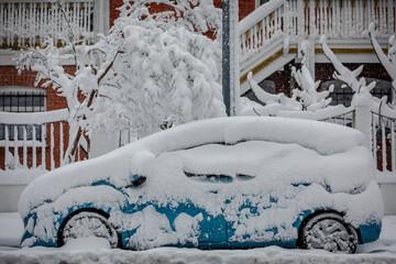 Side-View of blue Car parked in Street covered under heavy Snow; Copy Space